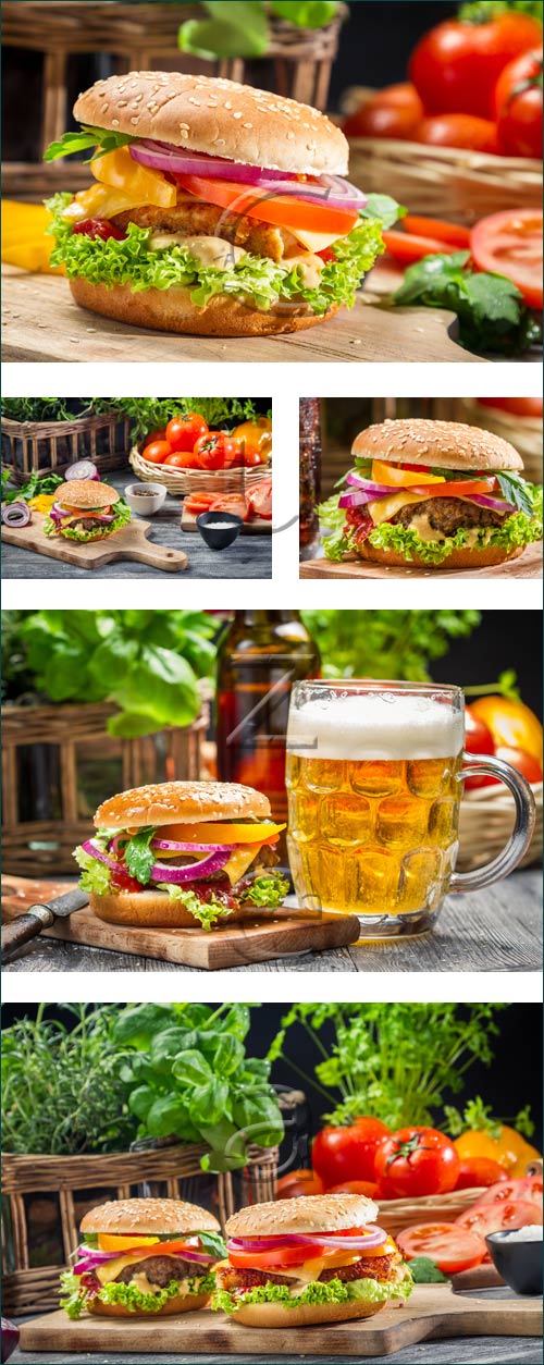 Cheeseburger, tomato and beer on wood - stock photo